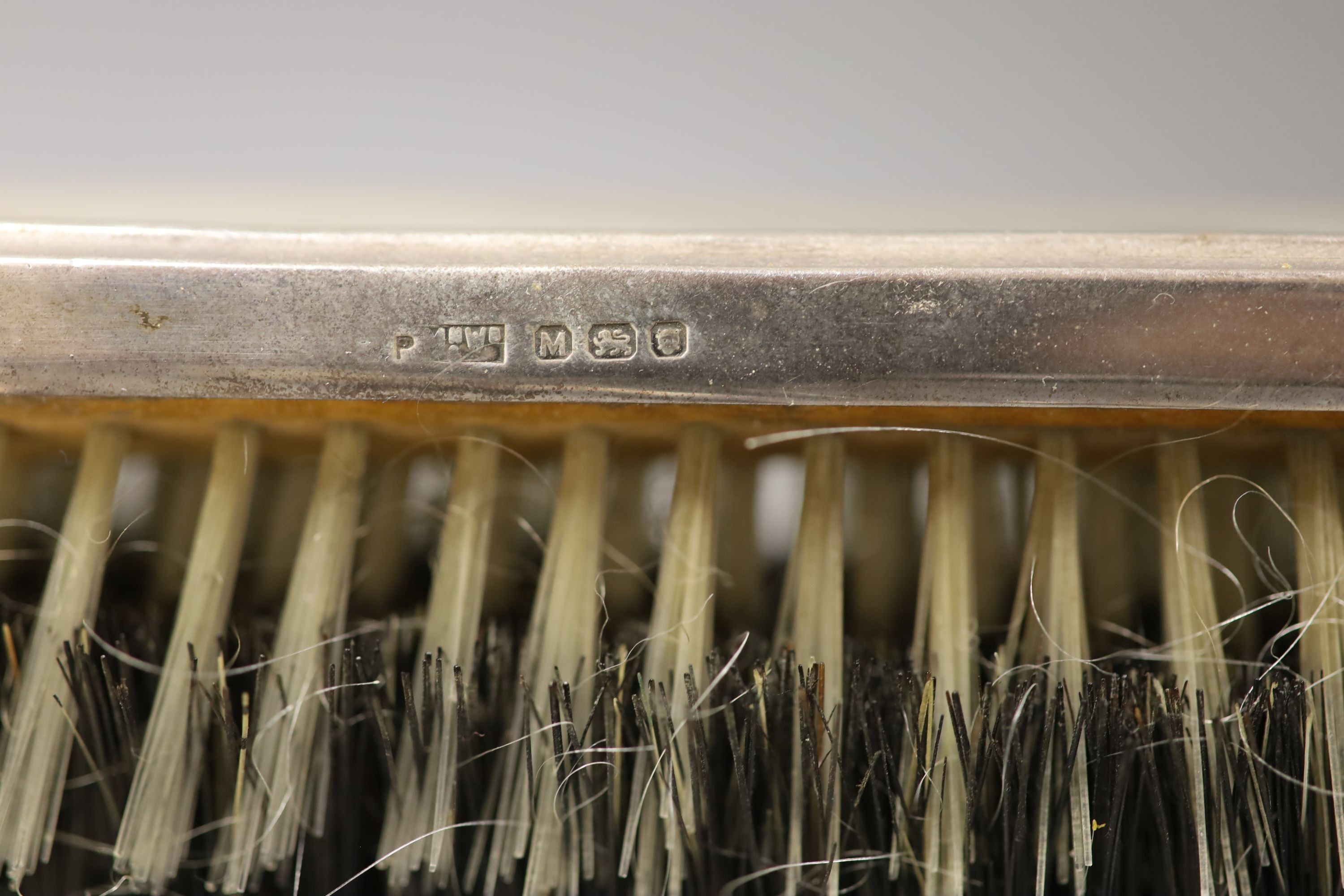 A 1940's silver mounted hand mirror and a group of other silver or sterling mounted brushes etc.